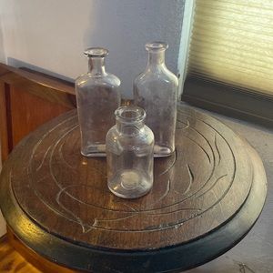 Three vintage bottles with purple hues